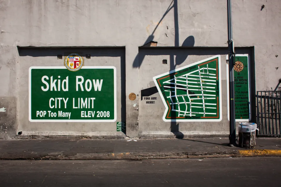Green Skid Row mural satirizing city limit sign in downtown Los Angeles, California.